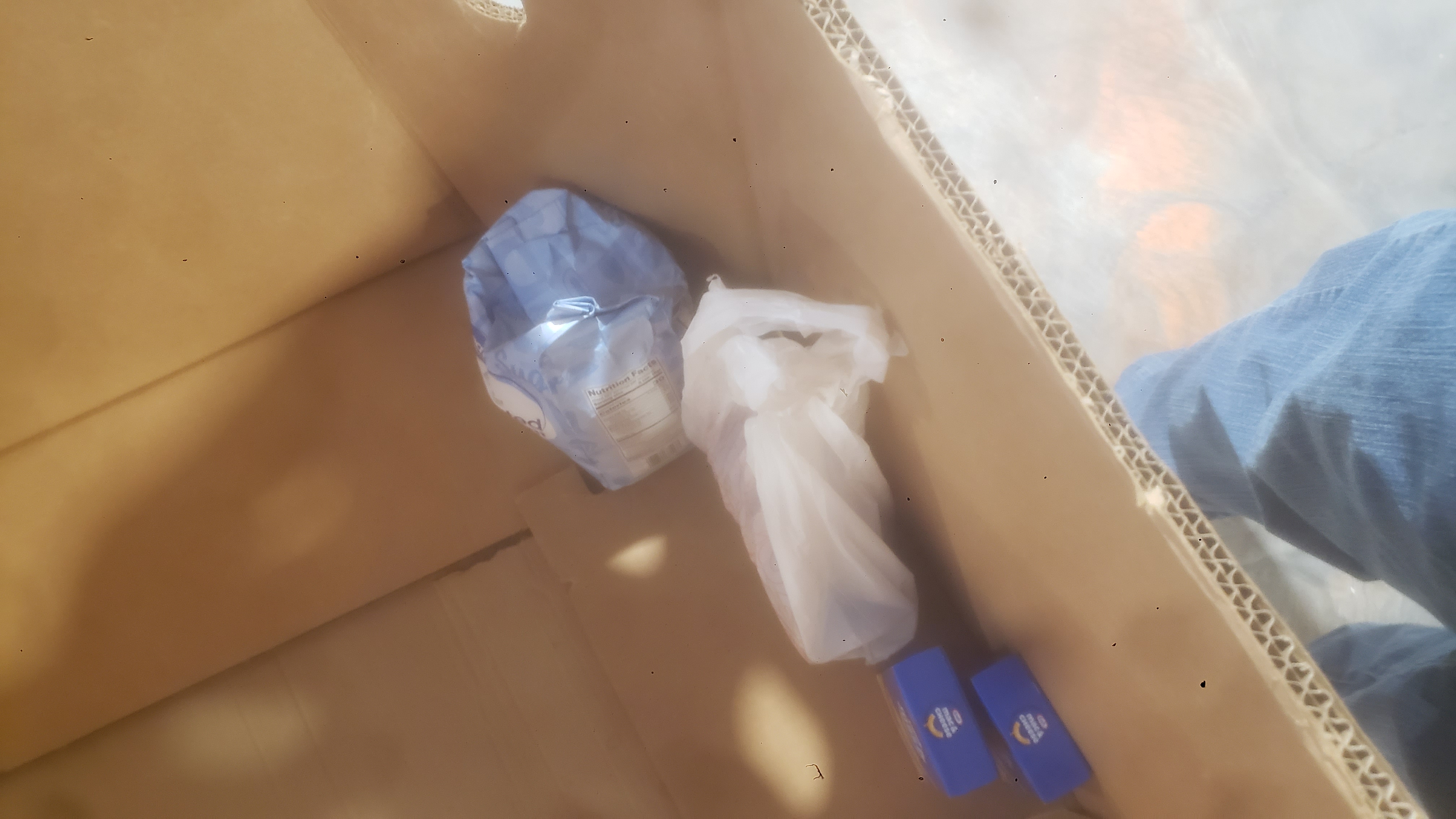 Four food items fill the bottom of a cardboard container.